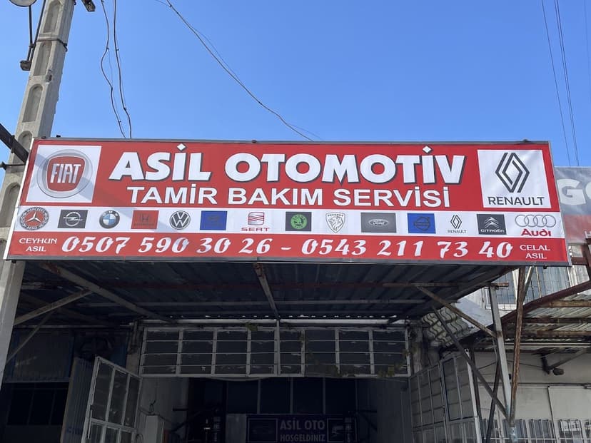 ASIL OTOMOTIV tabelası — çok markalı servis (yakın çekim)