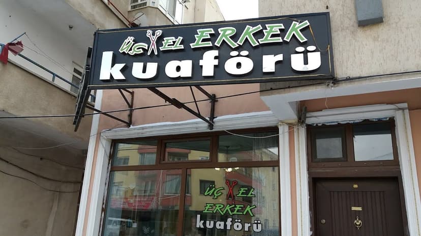 Üç-El Erkek Kuaförü dükkân tabelası ve dış görünüm