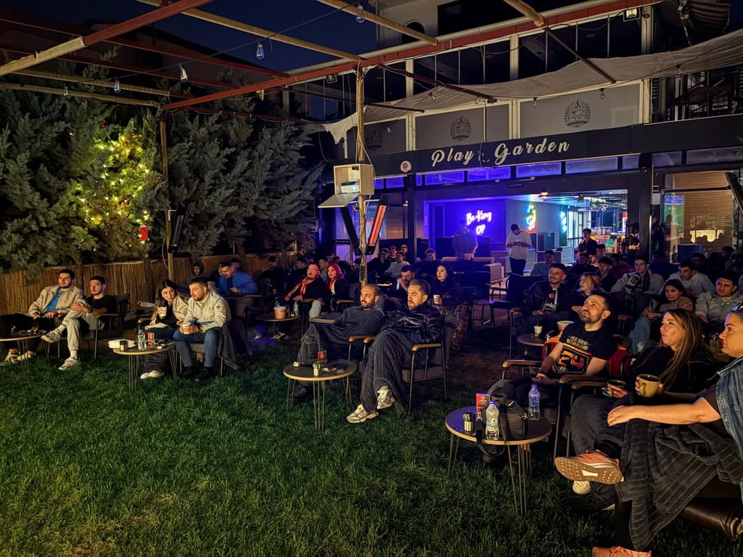 Bahçede dev ekranda maç yayını ve dolu masalar